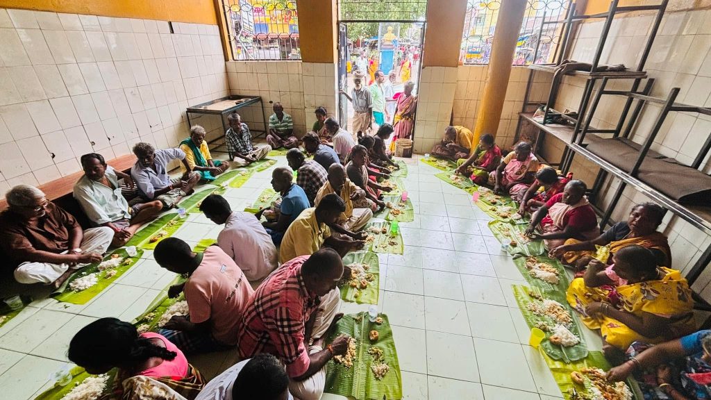 Community members sharing an annadhanam meal